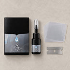 Chipmend kit laid flat: the box, a resin bottle with nozzle and cap, a stack of clear film squares and a razor blade, as shown in the photo